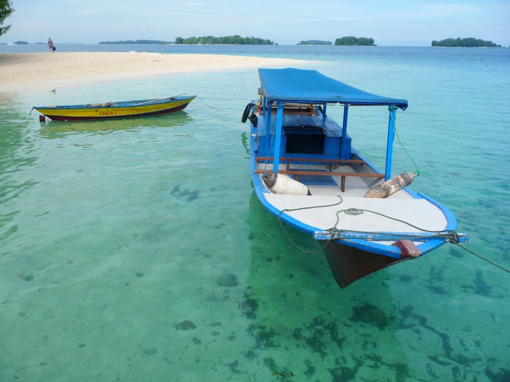 Asie Indonésie mille îles Java plage farniente Putri Island paradisiaque Petites barques sur une eau claire devant une langue de sable déserte 