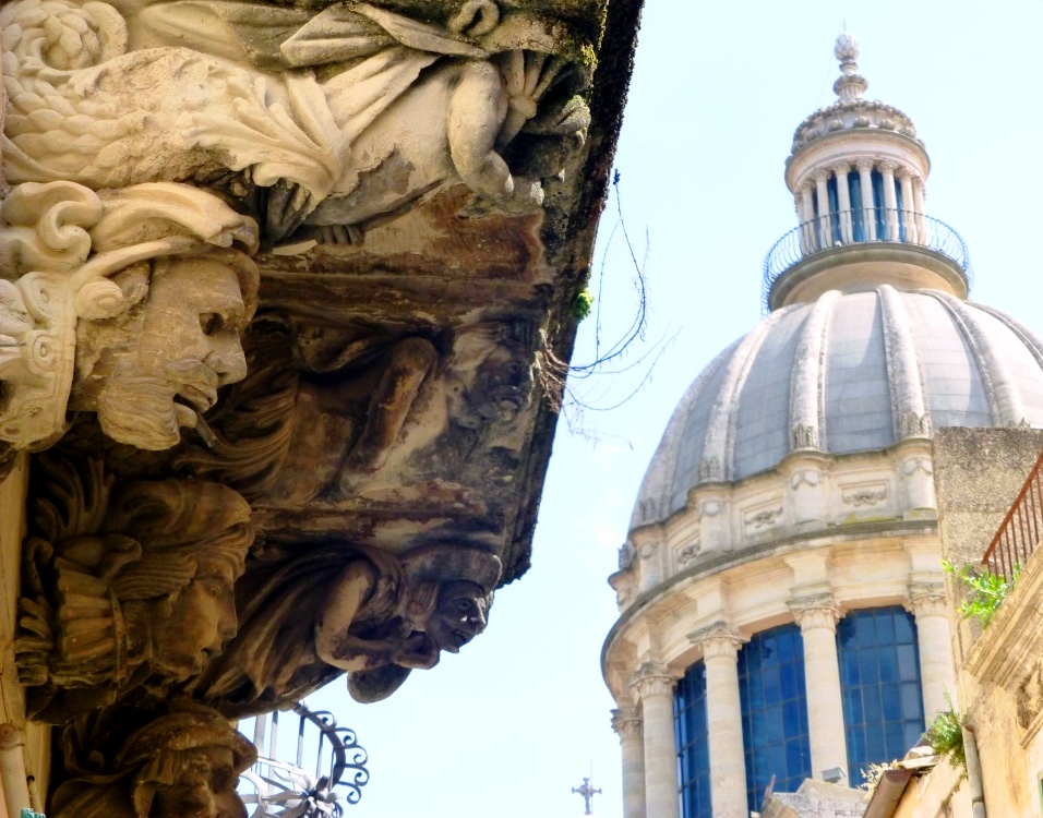 Une foule de personnages sous ce balcon semble regarder le Duomo di San Giorgio au centre de Ragusa Ibla 